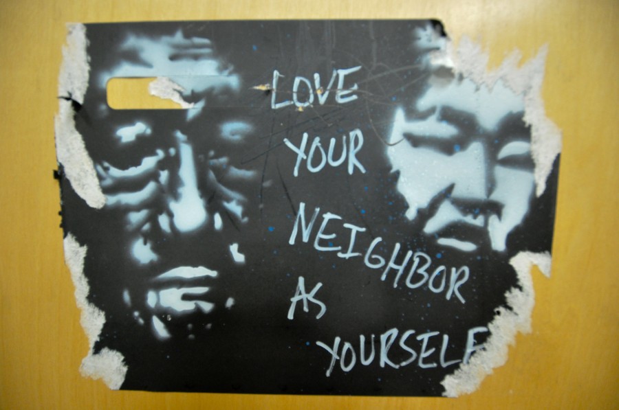 Photo two faces obscured, eyes closed, text reads "Love your neighbor as Yourself"